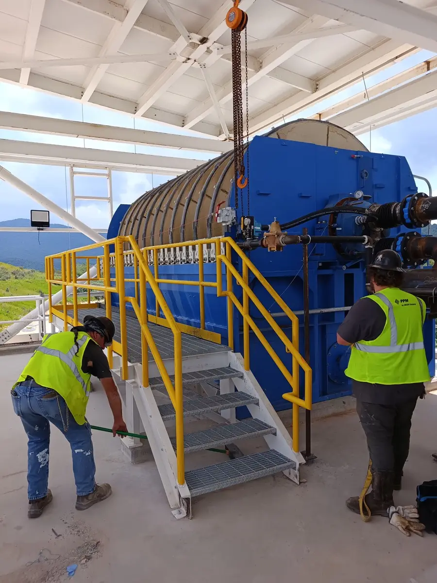 Crew commissioning a vacuum drum filter under a new steel canopy, North Carolina